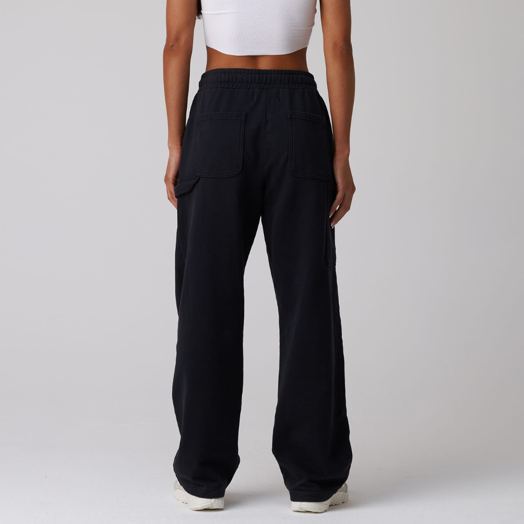 black jersey carpenter sweatpants with an adjustable toggle hem at the ankle, featuring multiple pockets.