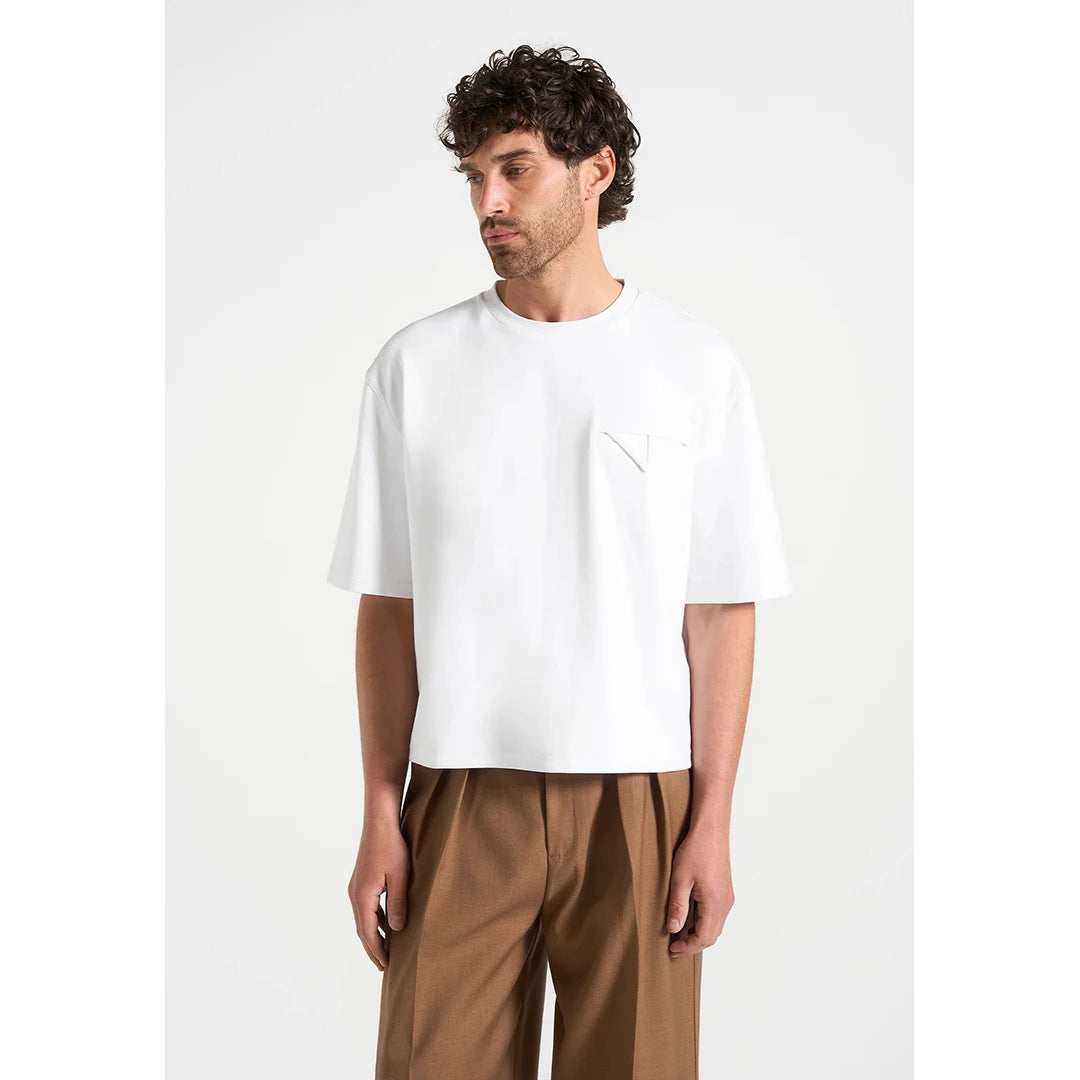 Man wearing a white t-shirt and brown pants on a white background