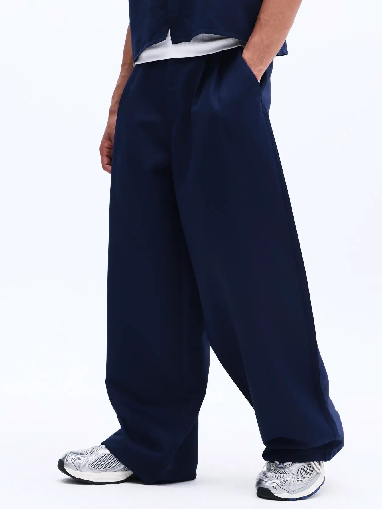Navy blue pants worn by a person on a white background
