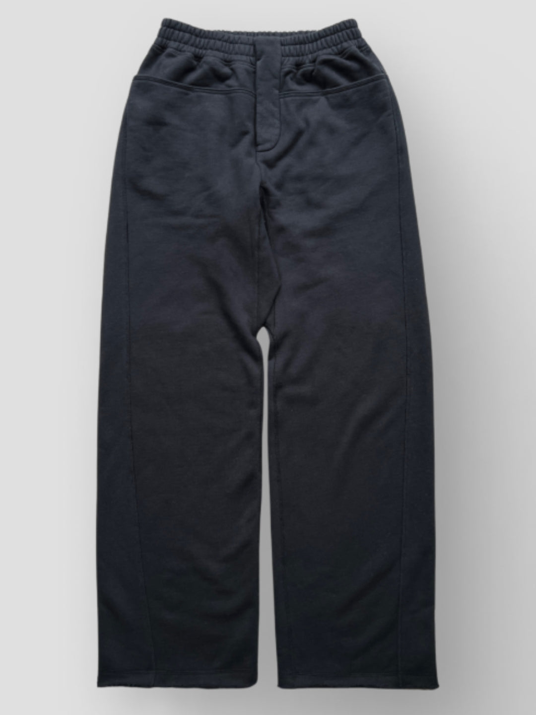  Black Sweatpant include a buttoned front fly, functional front and back pockets, and subtle construction details that add structure without compromising comfort. 