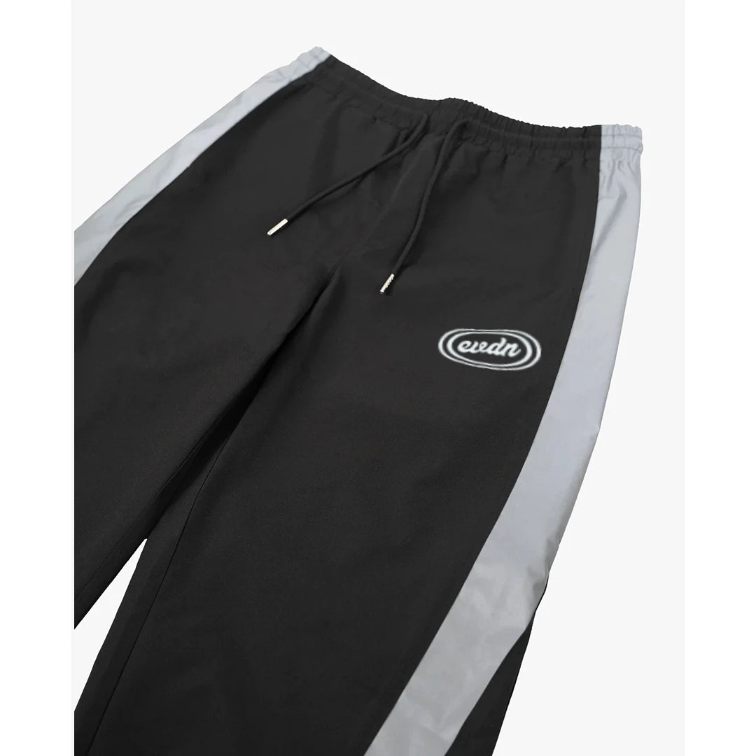 Black track pants with gray accents and a logo on a white background