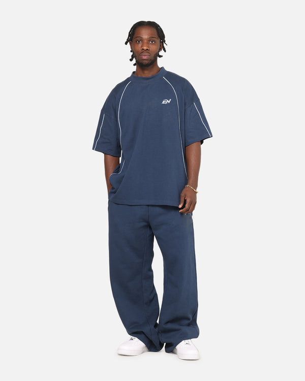 Person wearing a navy blue outfit with a logo on a white background