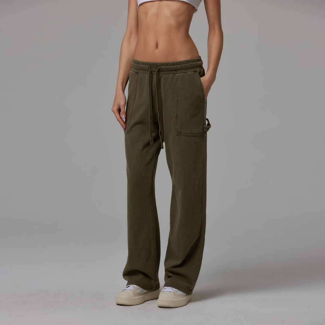 Olive jersey carpenter sweatpants with an adjustable toggle hem at the ankle, featuring multiple pockets.