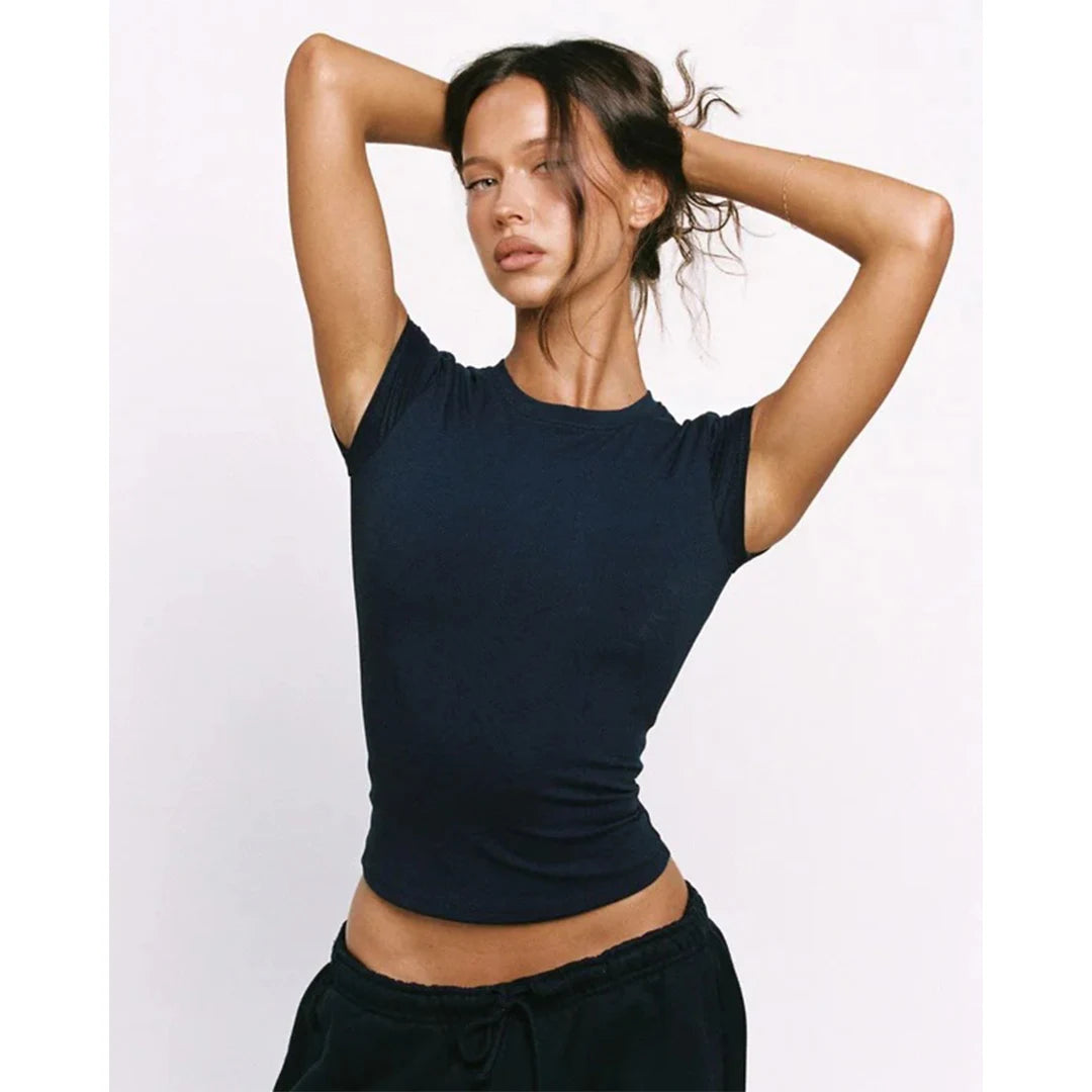 Woman wearing a black sleeveless top against a white background