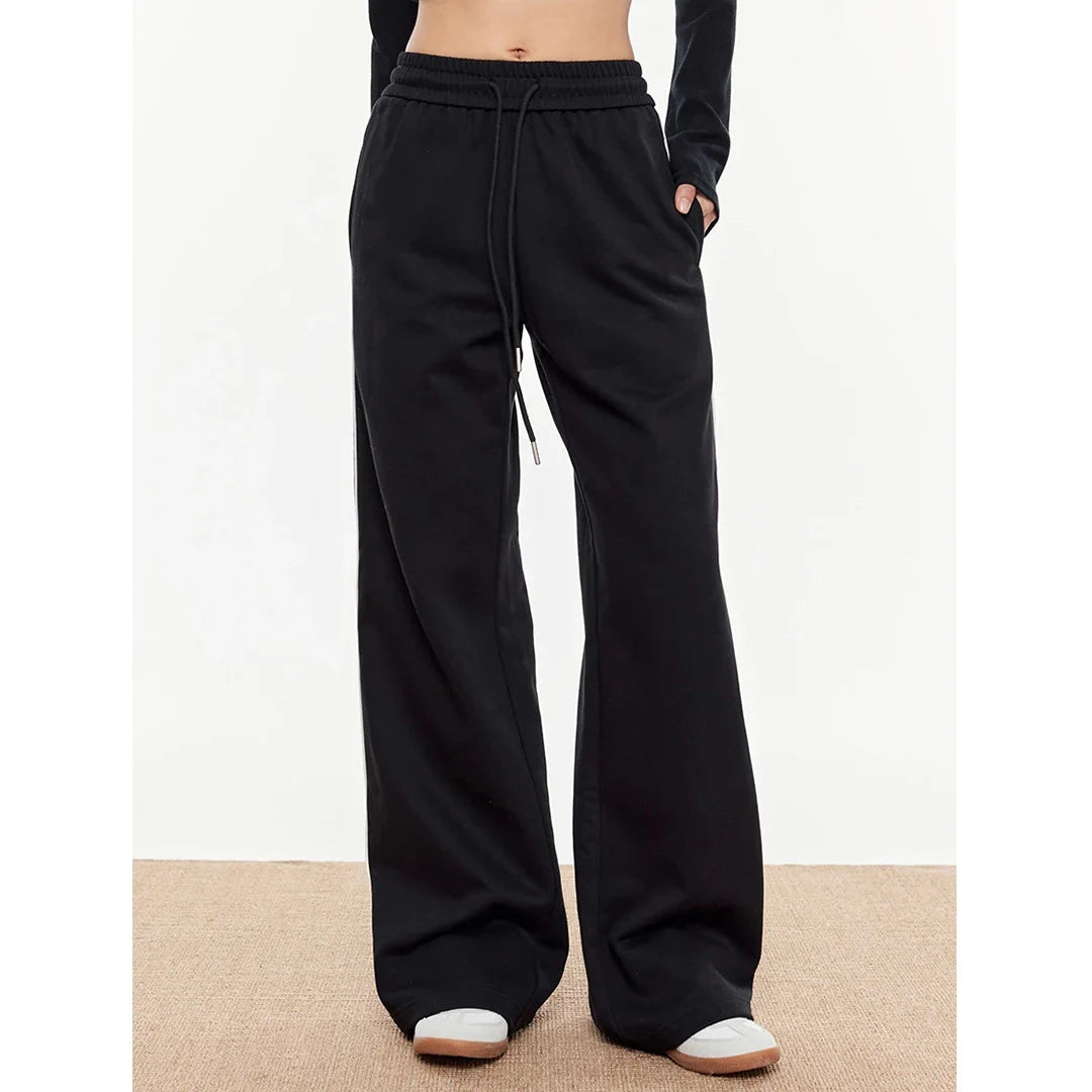 Black wide-leg pants worn by a person on a white background