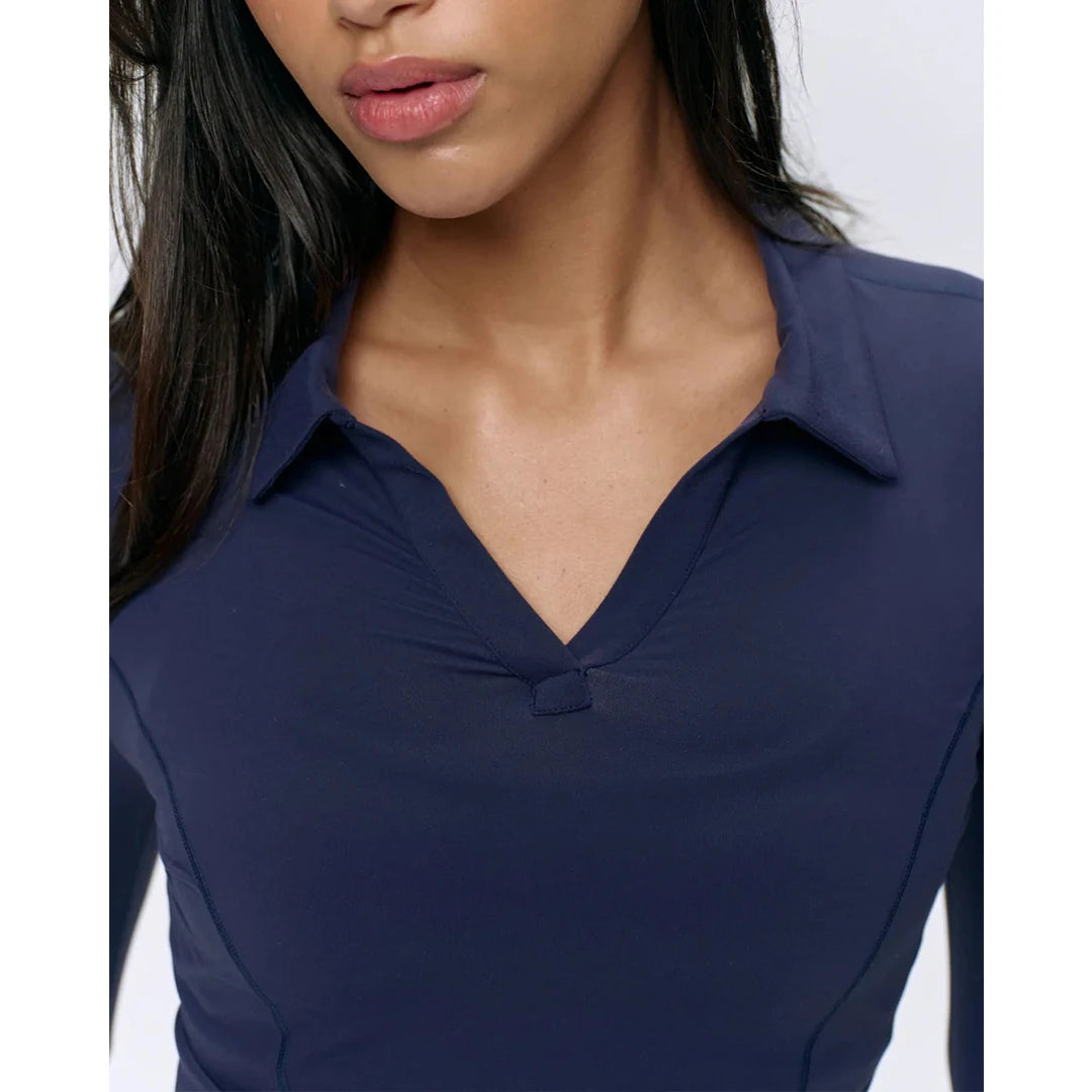 Navy blue long-sleeve top worn by a person on a white background