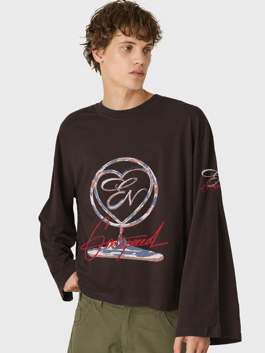 Person wearing a black long-sleeve shirt with a logo and text on a white background