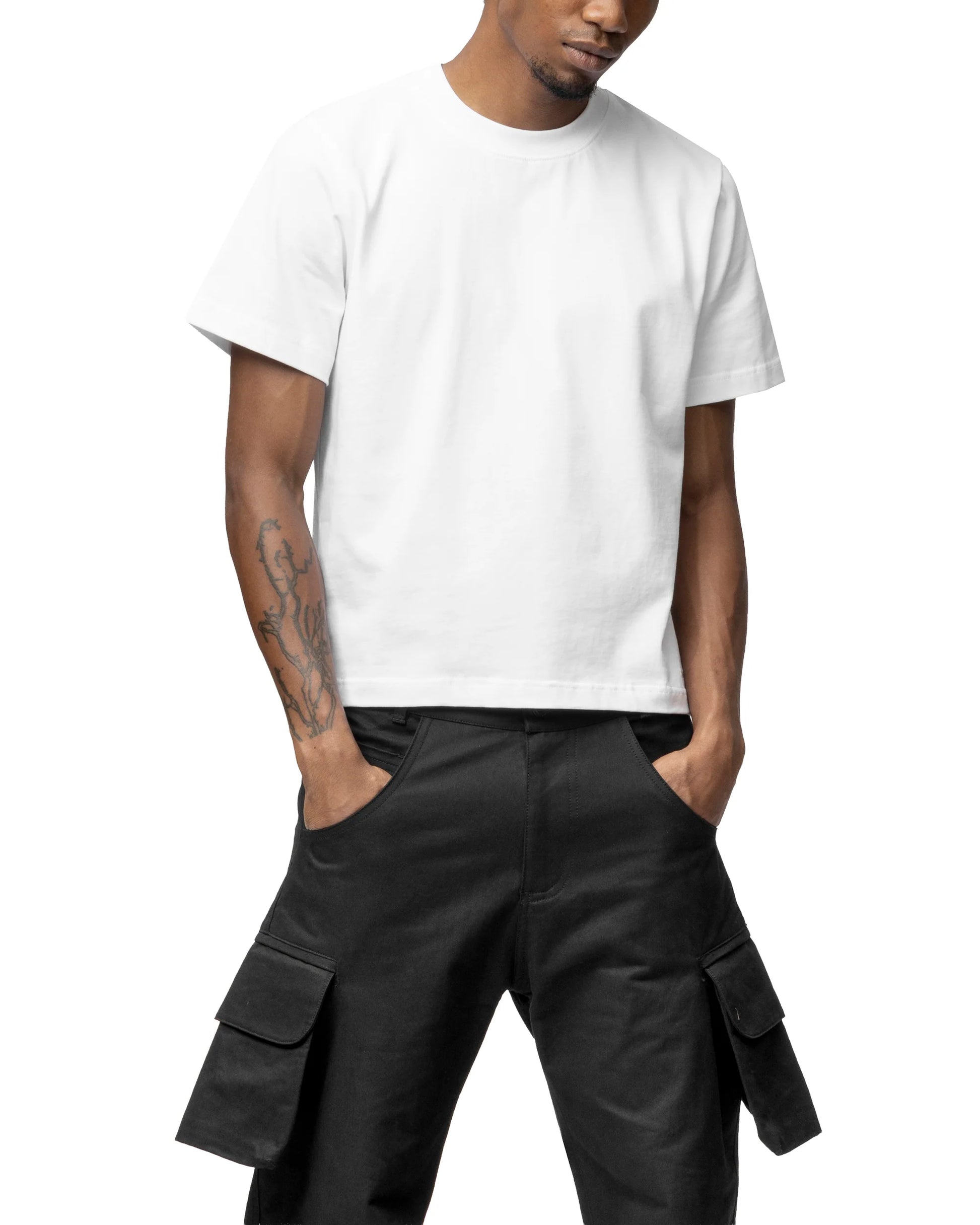 Person wearing a white t-shirt and black cargo pants on a white background