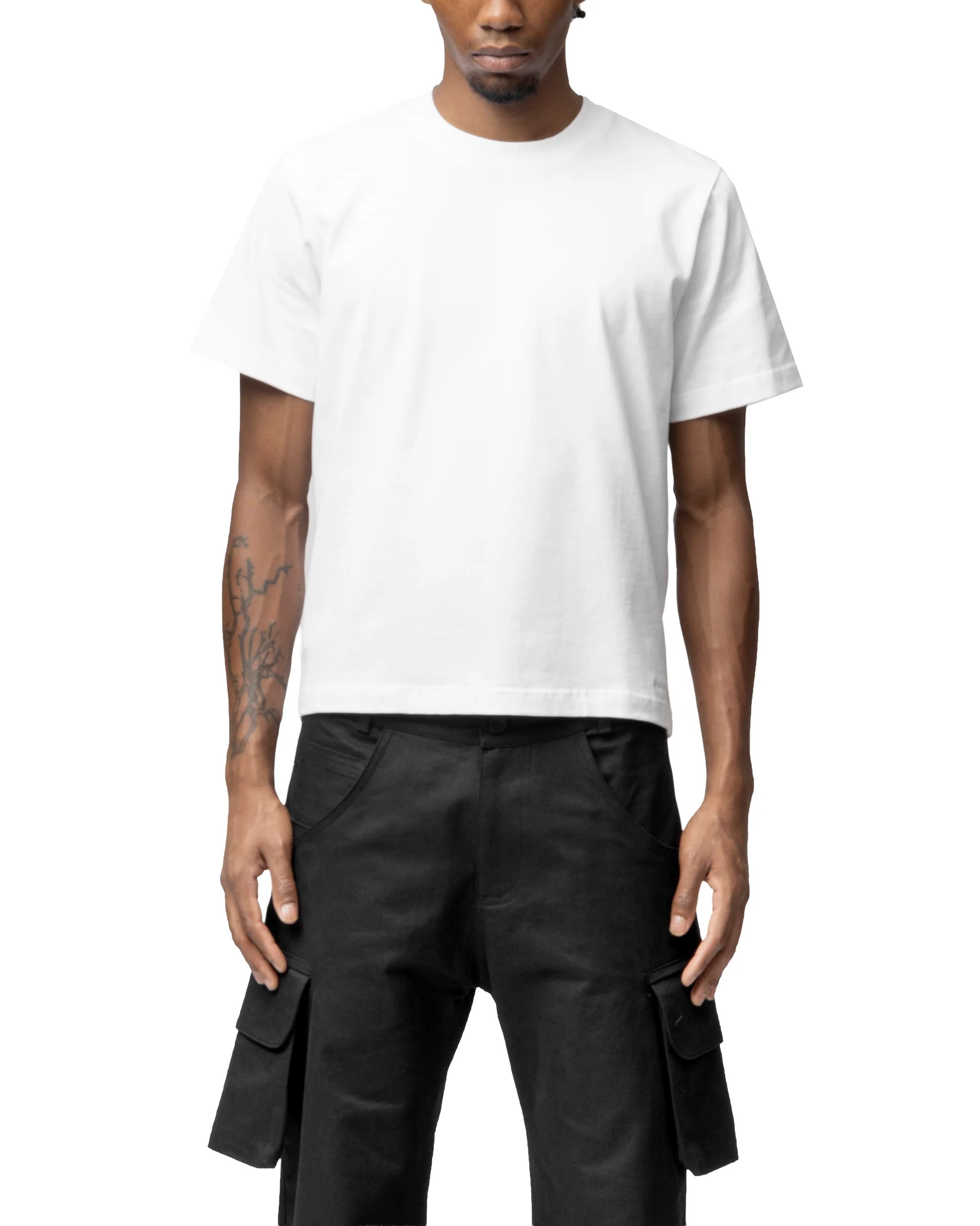 Person wearing a white t-shirt and black cargo pants on a white background