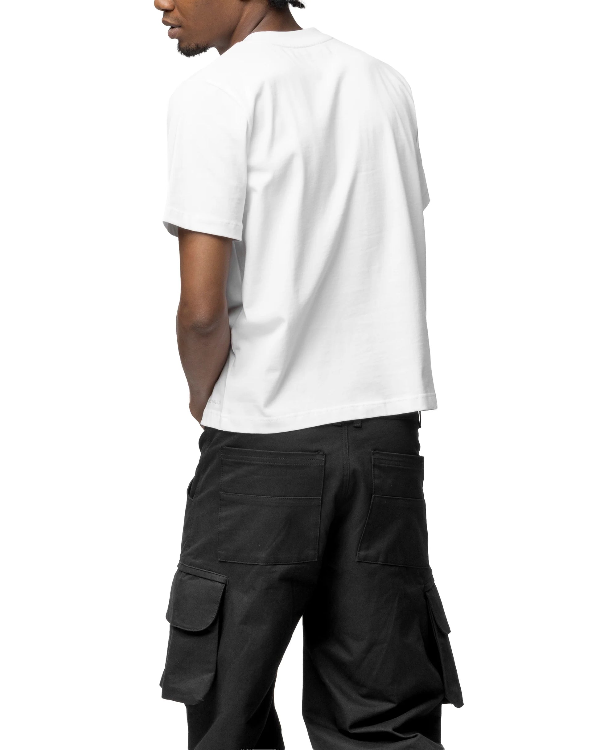 Person wearing a white t-shirt and black cargo pants on a white background