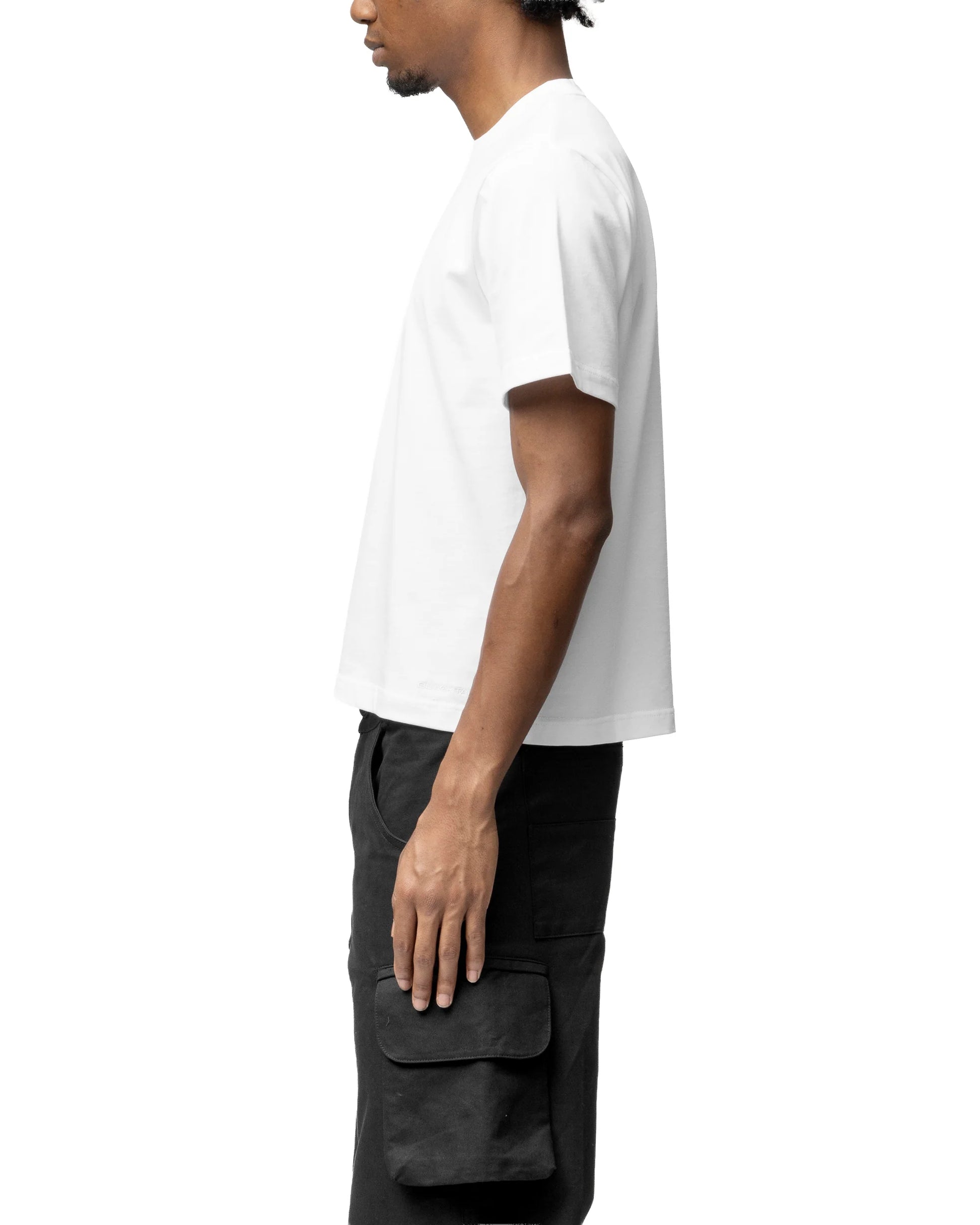 Person wearing a white t-shirt and black cargo pants on a white background