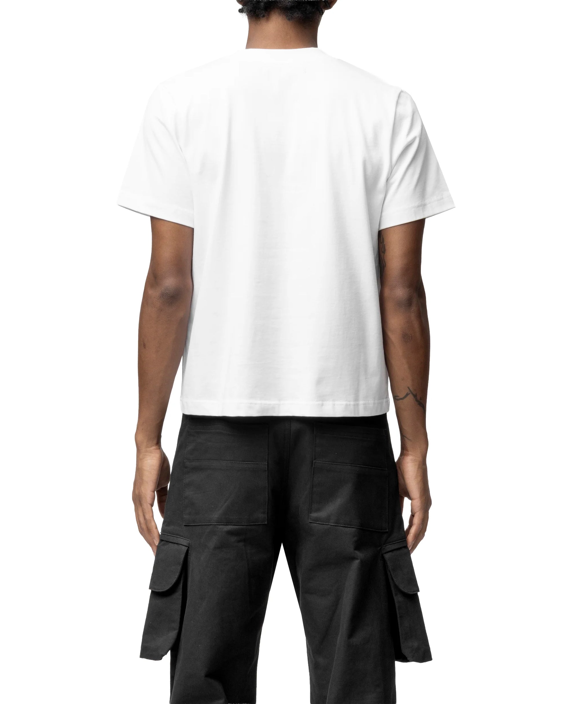 Person wearing a white t-shirt and black cargo pants on a white background