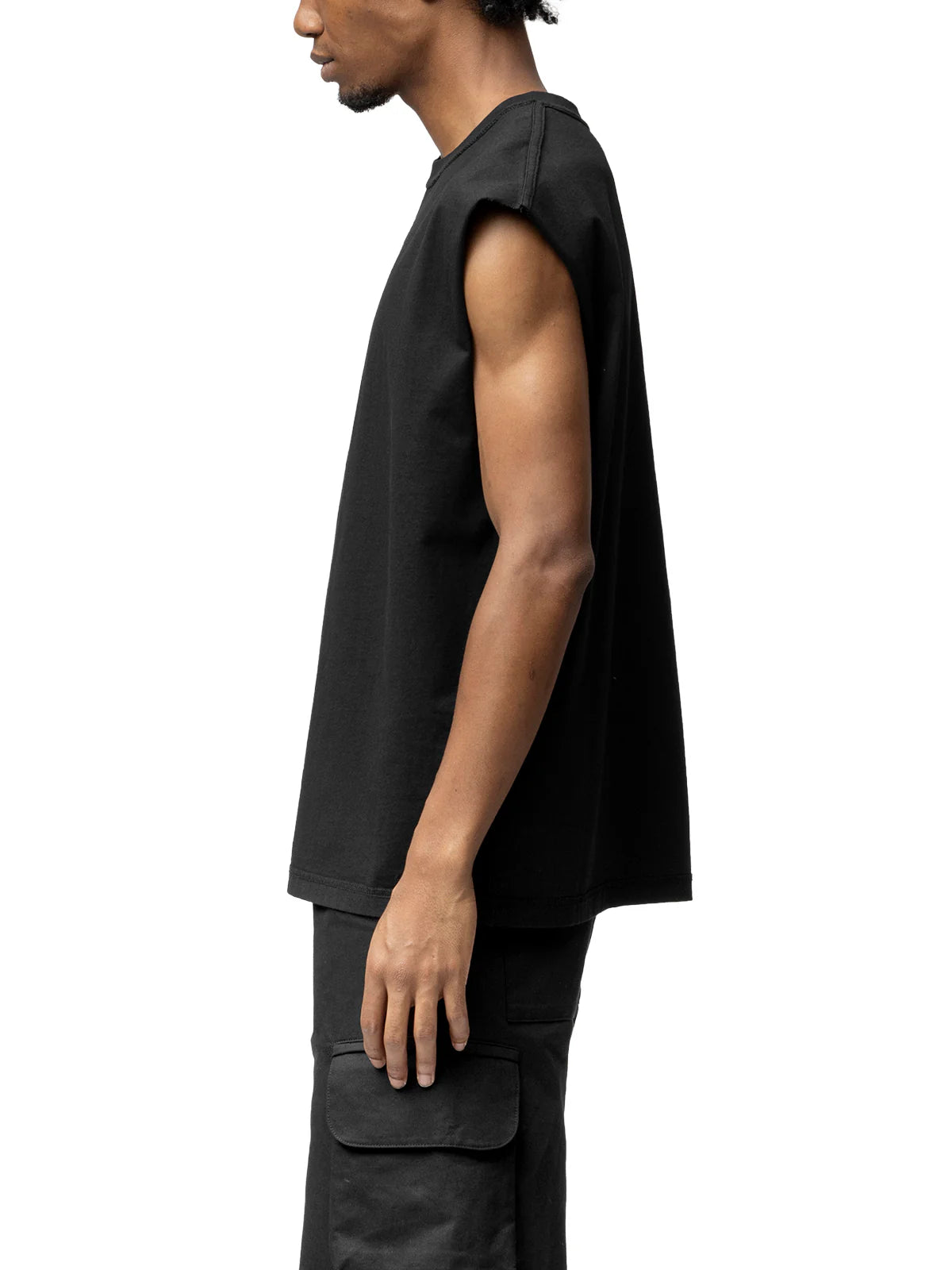 Person wearing a black sleeveless shirt and pants on a white background