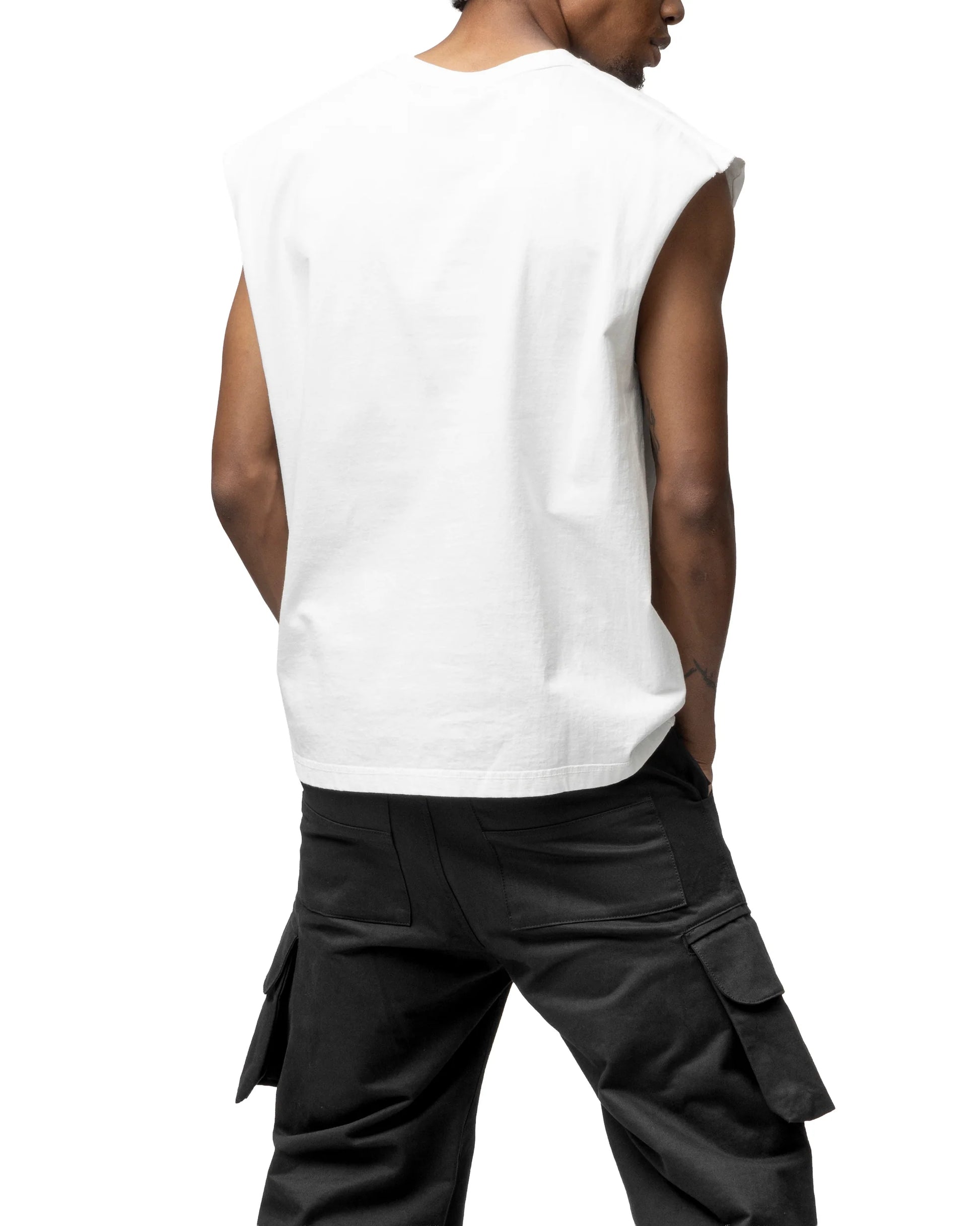 Person wearing a white sleeveless shirt and black cargo pants on a white background
