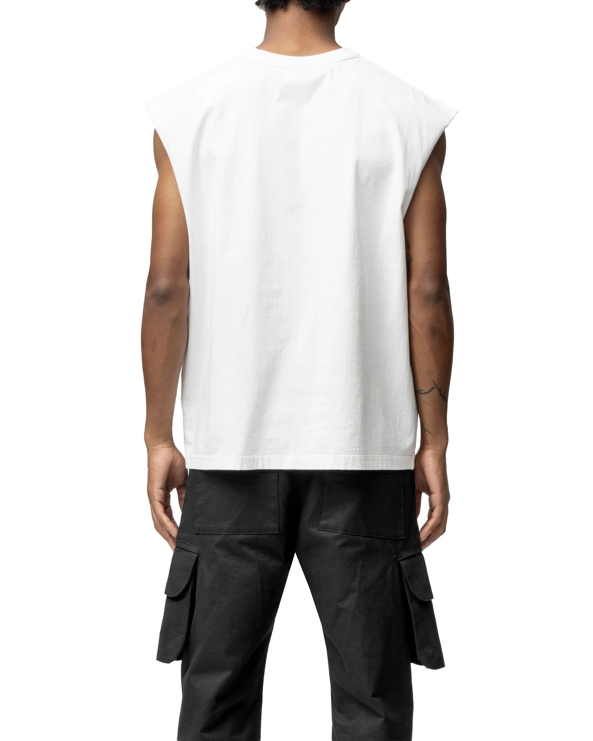 Person wearing a white sleeveless t-shirt and black cargo pants on a white background
