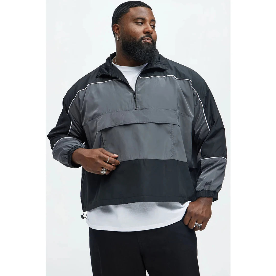 Man wearing a black and gray jacket on a white background