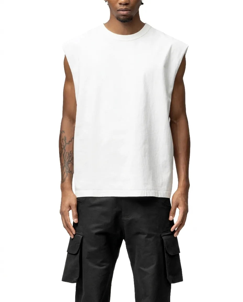 Person wearing a white sleeveless shirt and black cargo pants on a white background