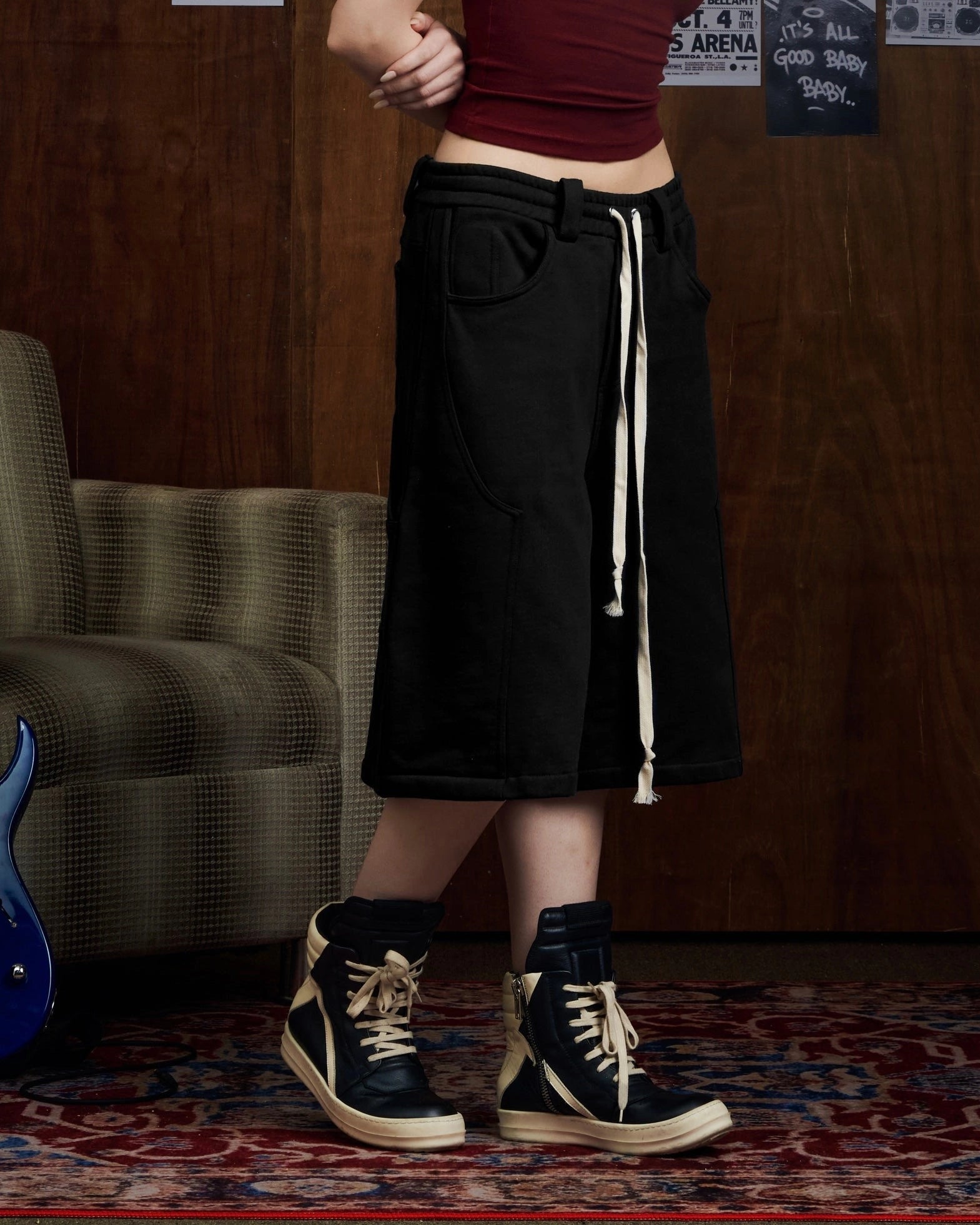 Oversized black carpenter shorts with elastic drawstring waist and wide-leg fit