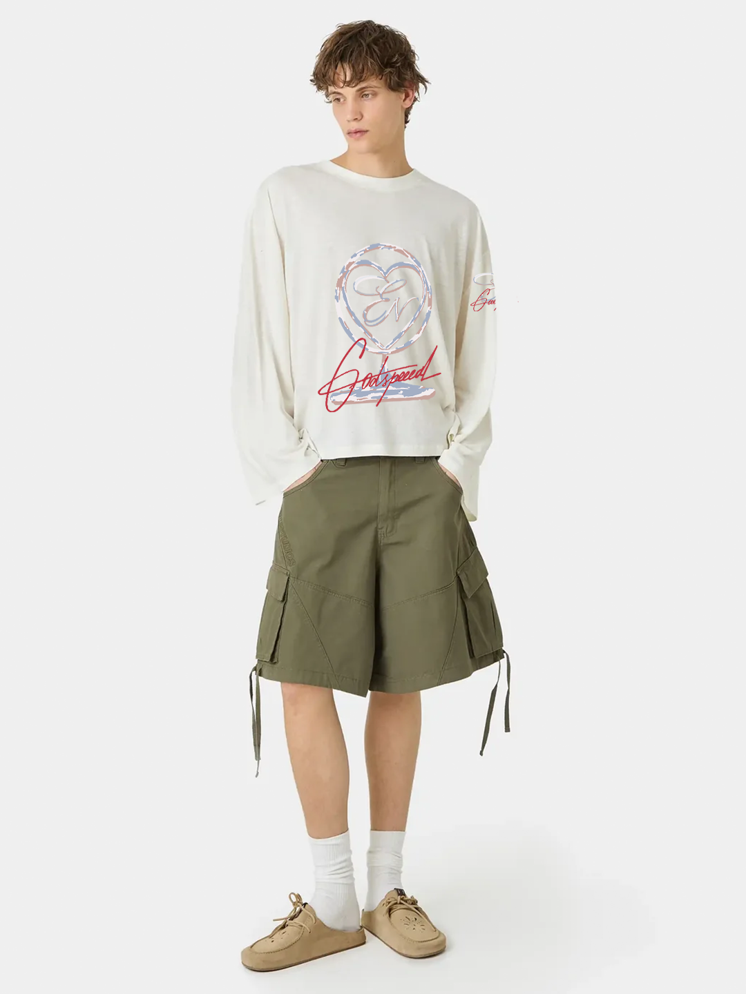 Person wearing a graphic sweatshirt and green skirt on a white background