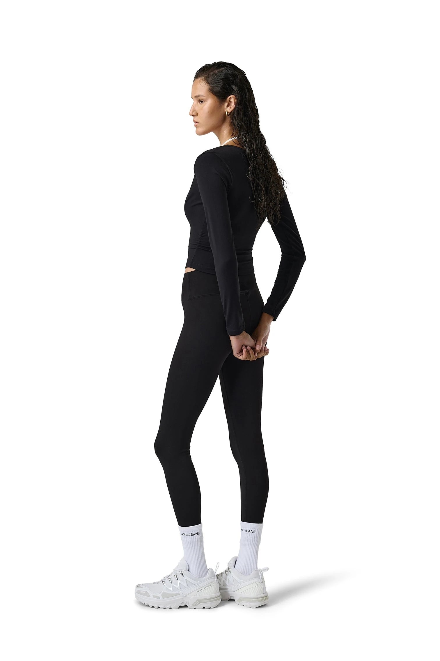 Person wearing a black athletic outfit on a white background
