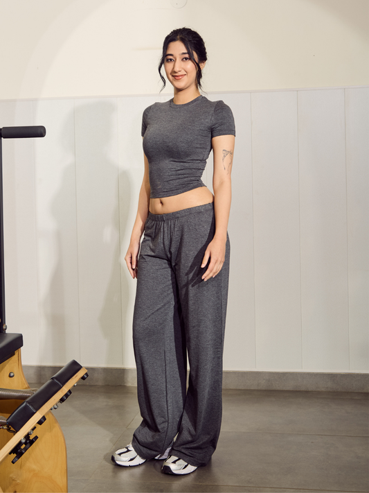 Woman in grey athletic wear standing in a gym setting