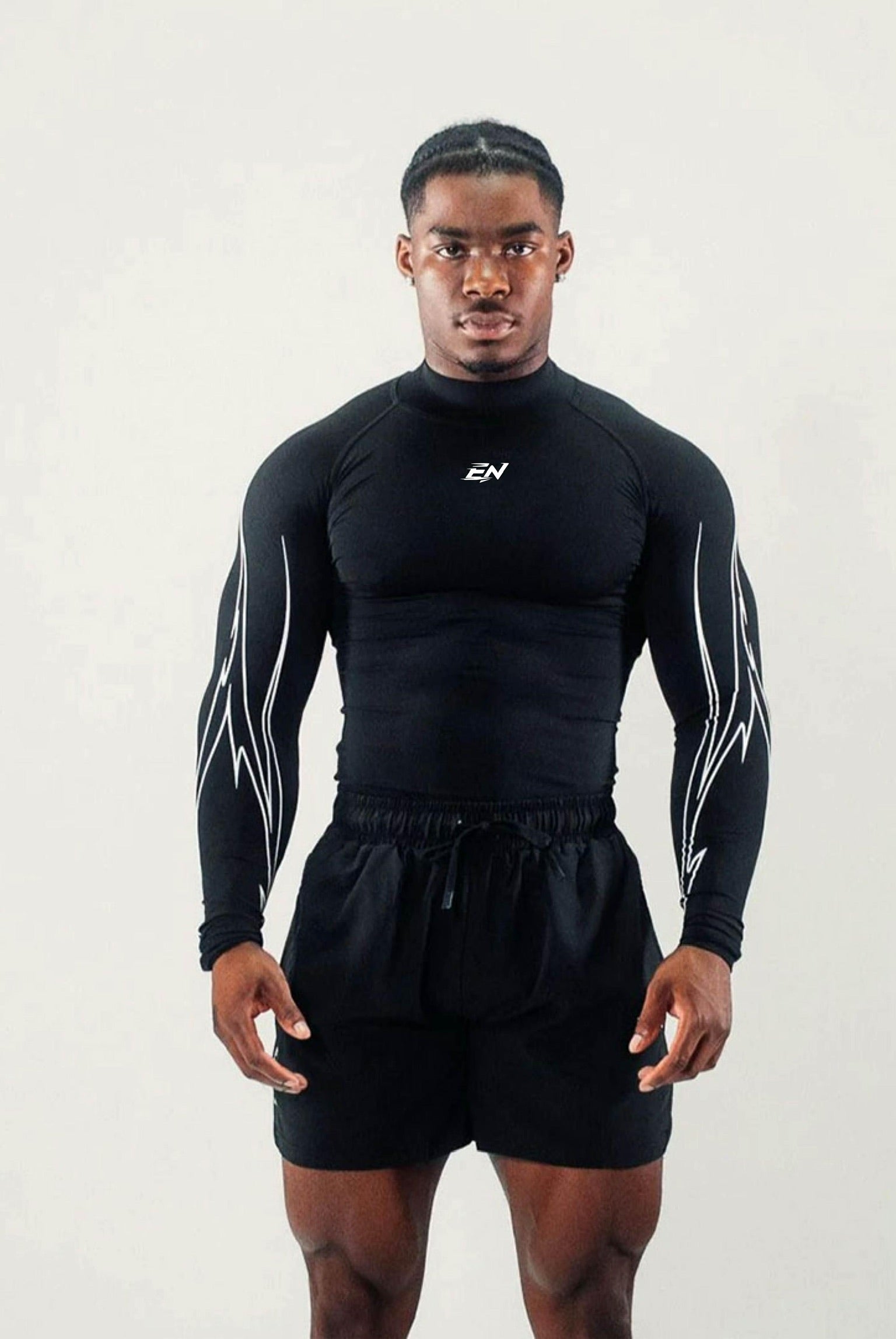 Person wearing a black athletic outfit with a logo on a white background