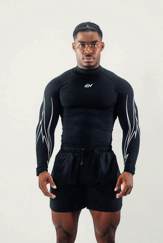 Person wearing a black athletic outfit with a logo on a white background
