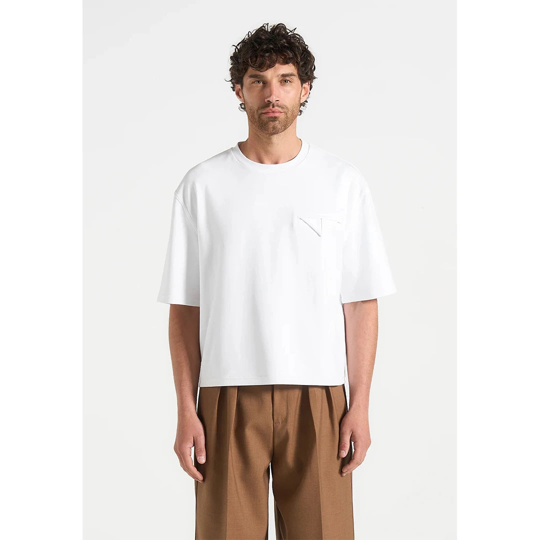 Man wearing a white t-shirt and brown pants on a white background