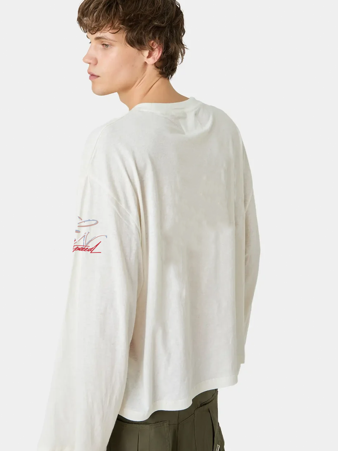 Person wearing a white sweater with red text on a plain background