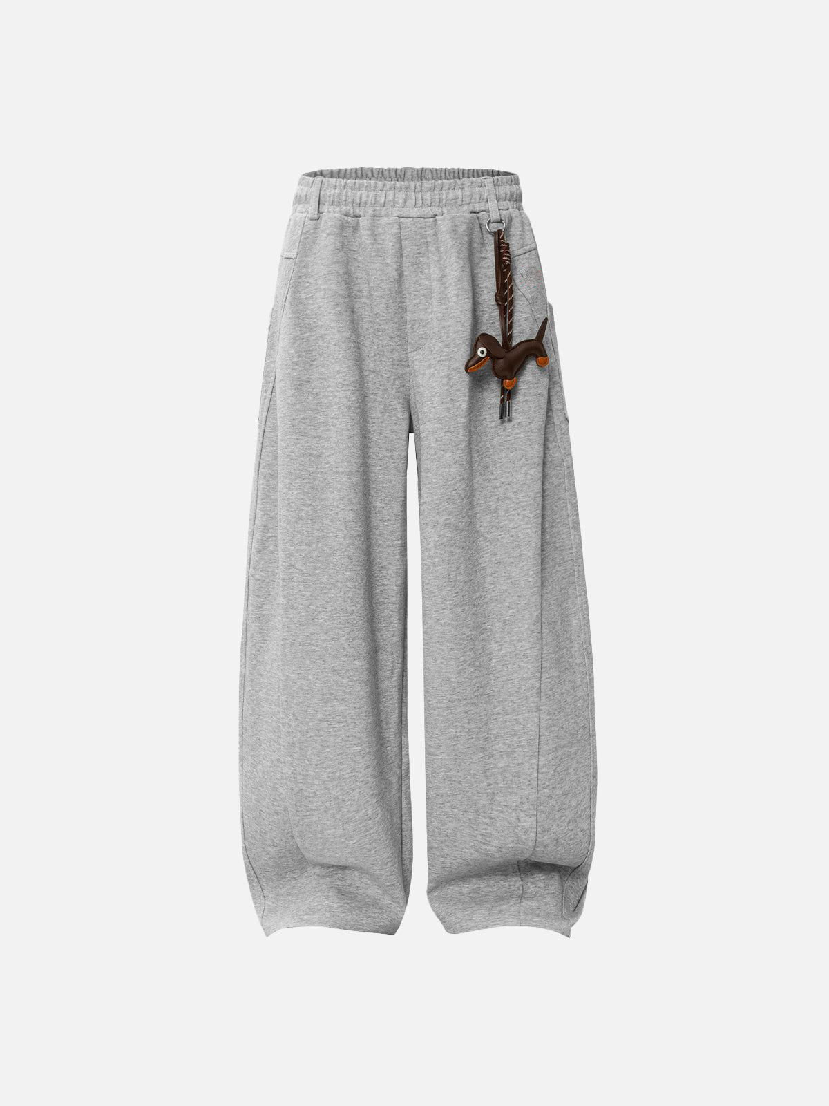 Grey sweatpants with a decorative item on a white background
