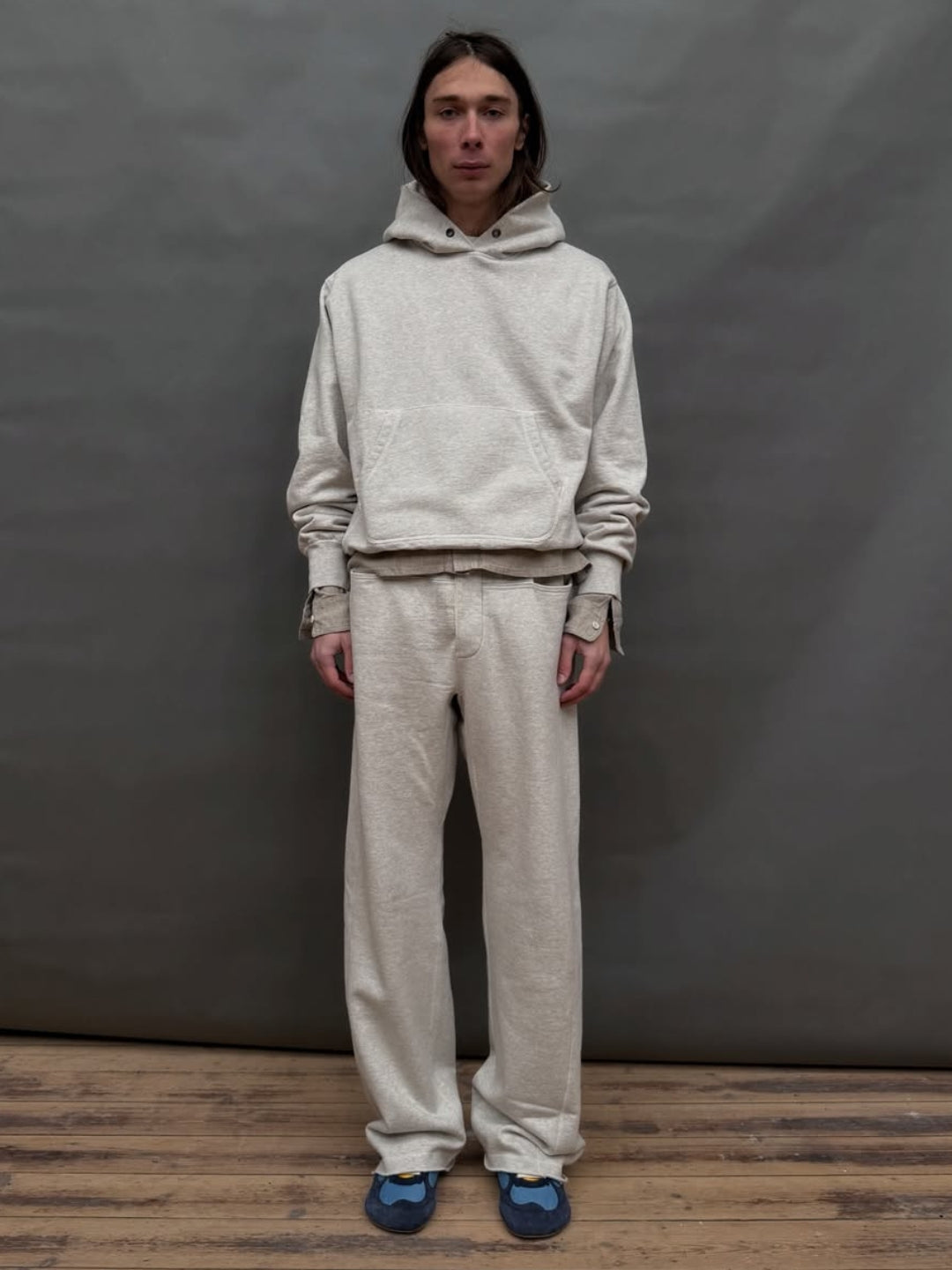  Grey Sweatpant include a buttoned front fly, functional front and back pockets, and subtle construction details that add structure without compromising comfort. 