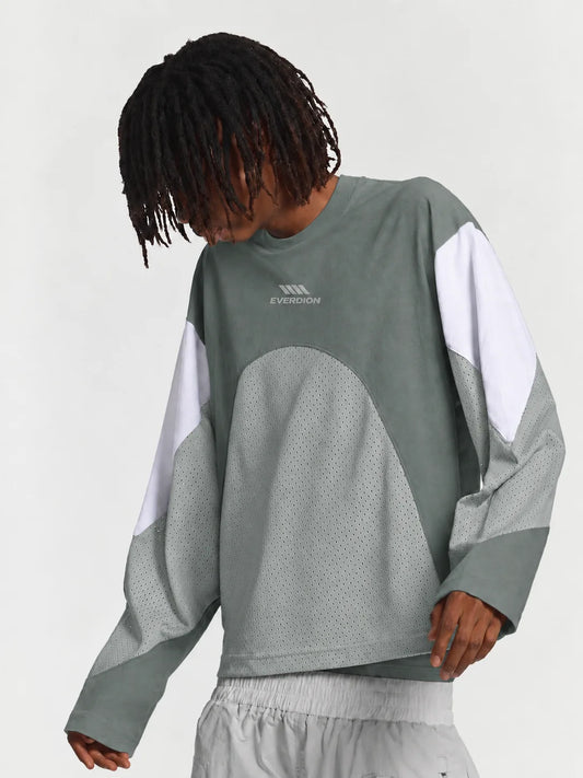 A person wearing a color-blocked long-sleeve sweatshirt in grey, white, and light grey, with a small 'EVERDION' logo on the chest, against a plain light grey background.