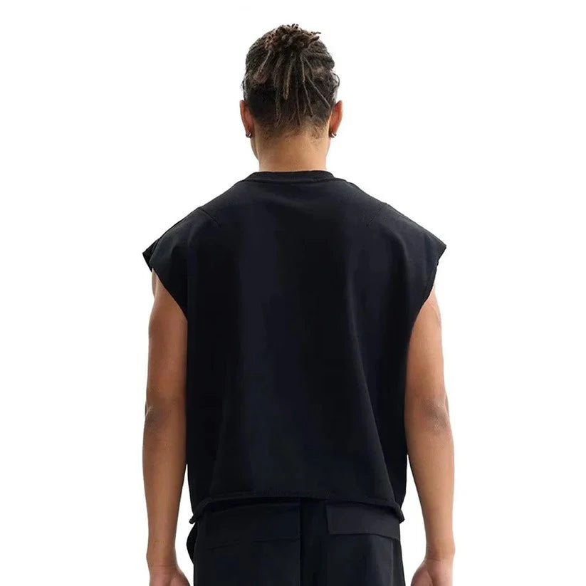 Person wearing a black sleeveless tank top on a white background