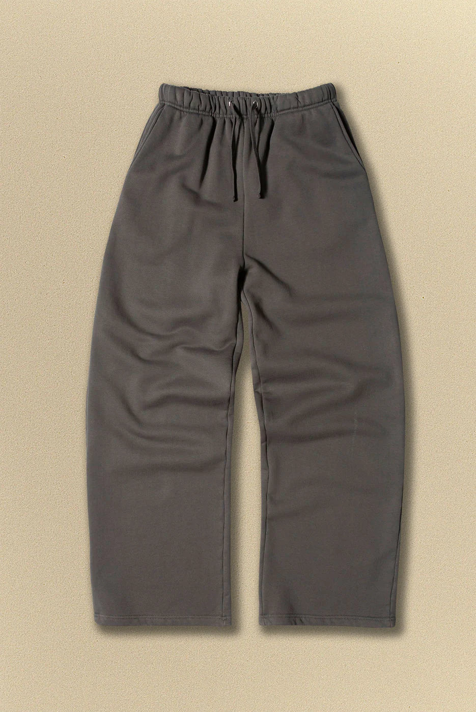 Grey pants with drawstring on a beige background