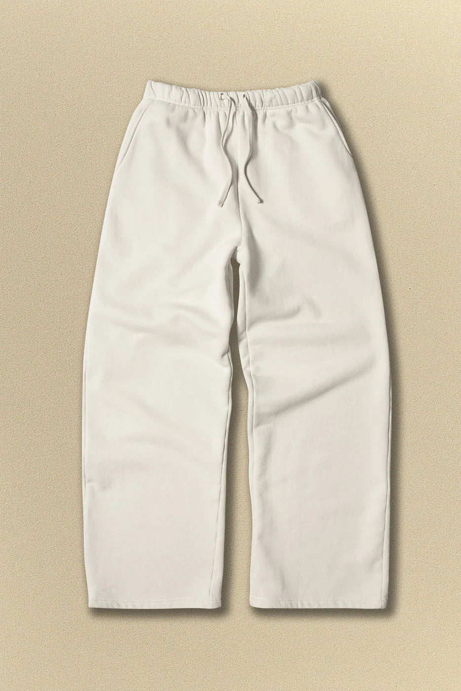 Light grey pants with drawstring on a beige background