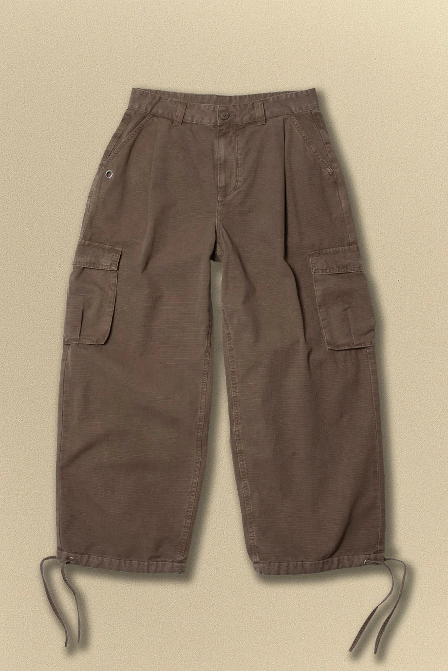 Brown cargo pants on a beige background