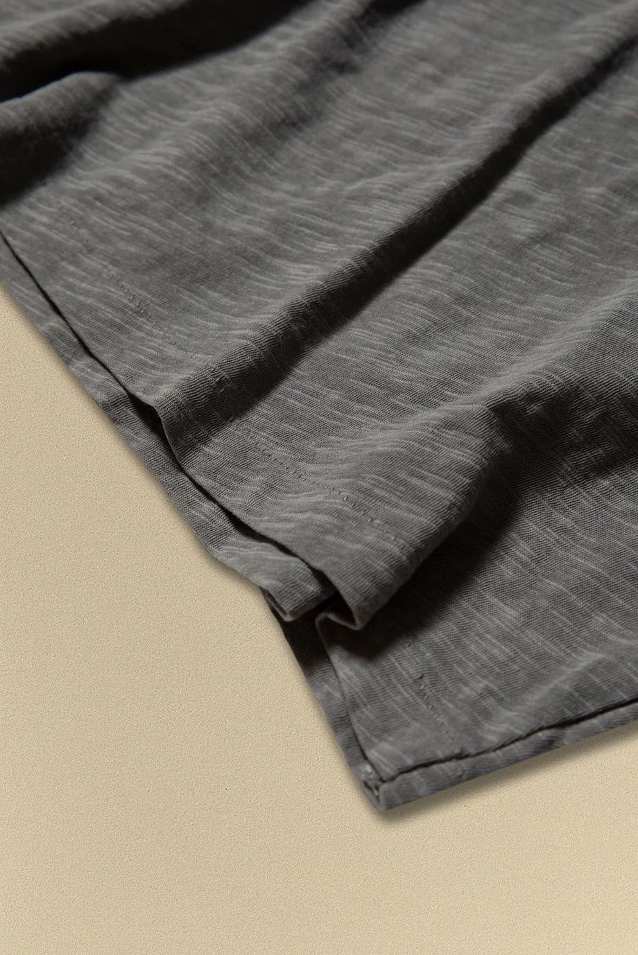 Grey fabric on a beige surface
