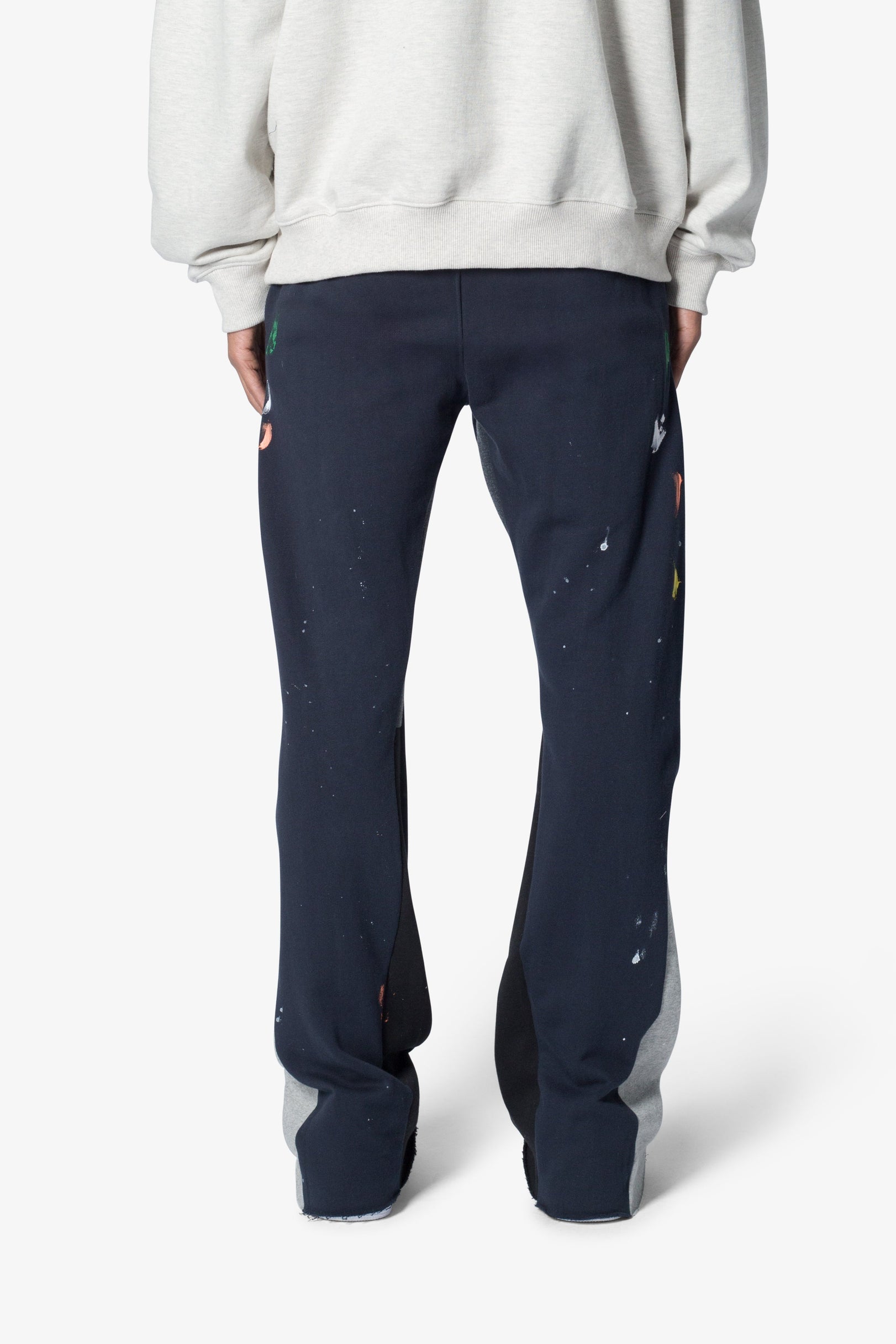 Navy pants with colorful accents worn by a person on a white background