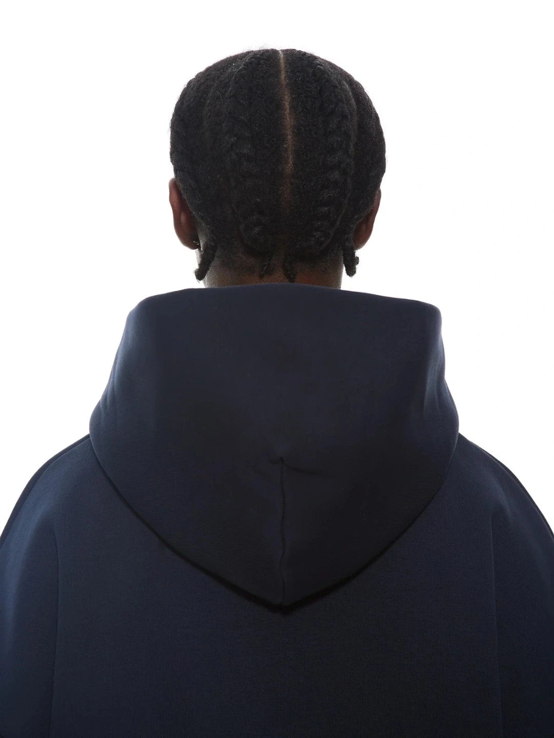 Person wearing a dark blue hoodie from behind on a white background