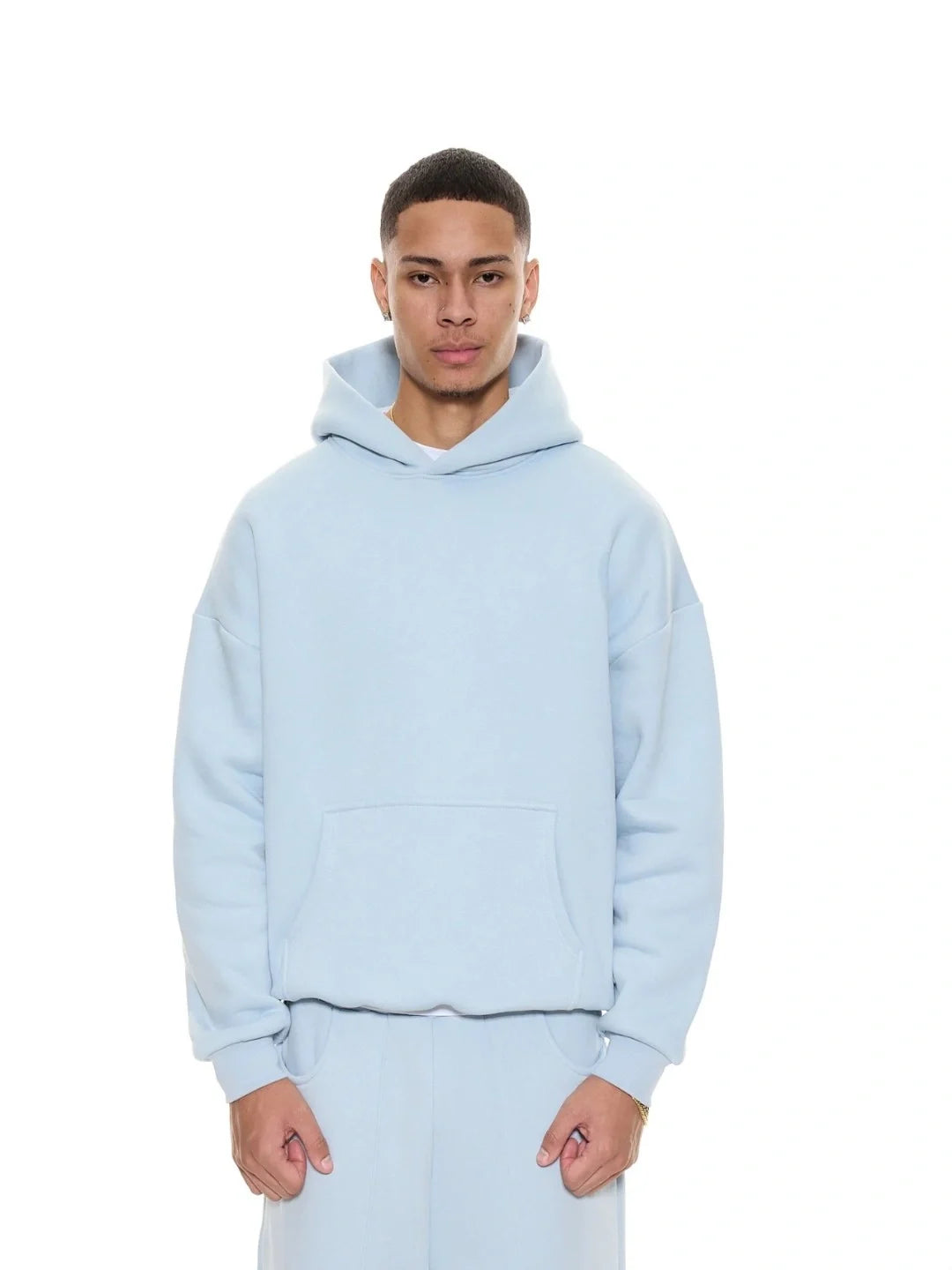 Person wearing a light blue hoodie on a white background