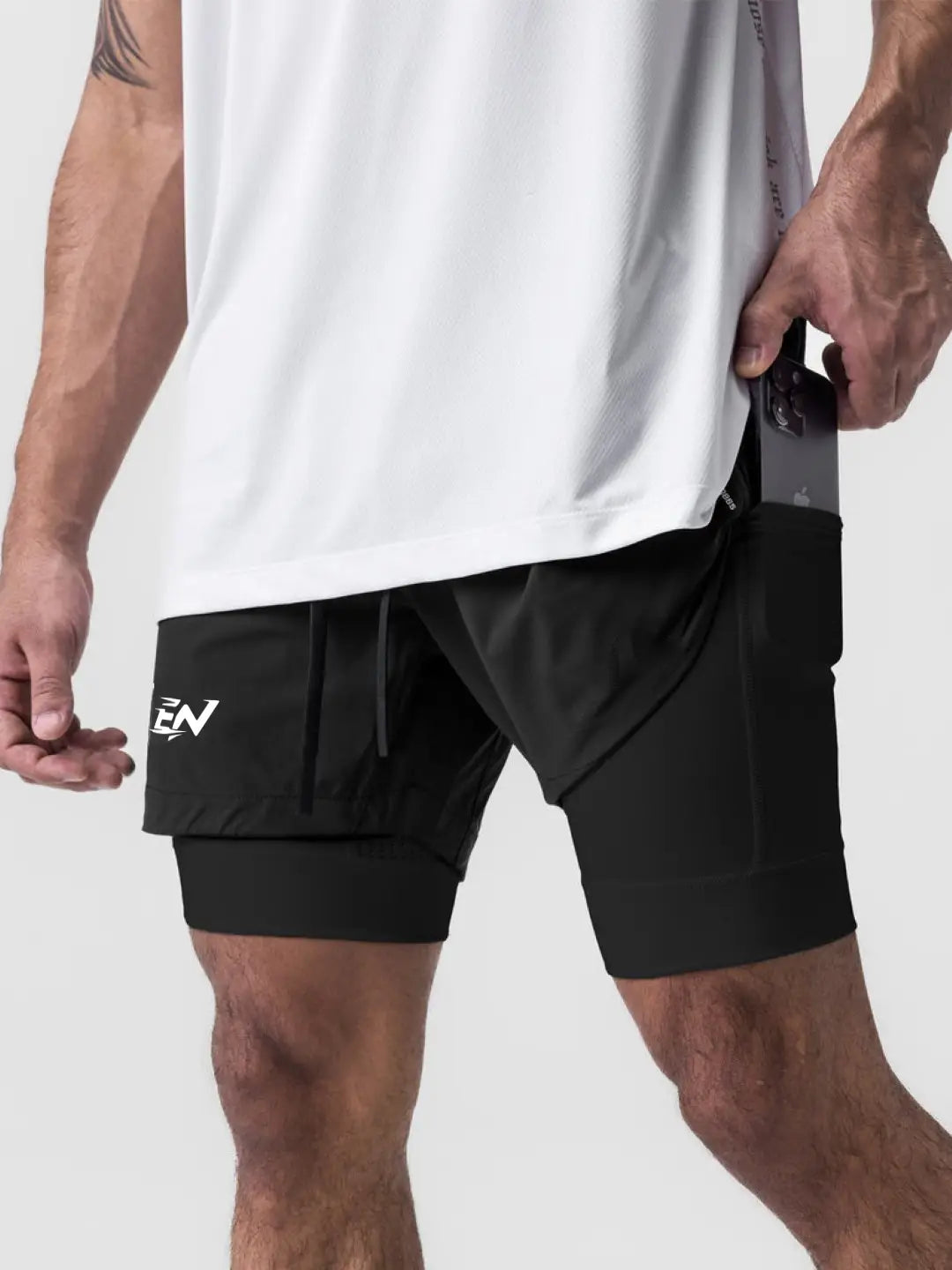 2-in-1 black shorts with inner compression media pockets, outer front pockets, a back zip pocket and a utility loop for training essentials.