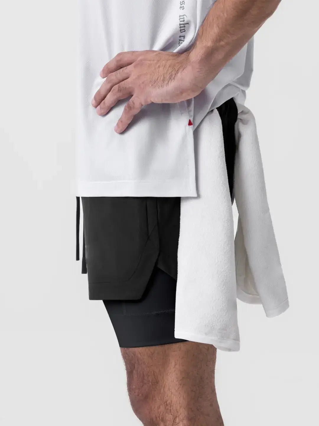 2-in-1 black shorts with inner compression media pockets, outer front pockets, a back zip pocket and a utility loop for training essentials.