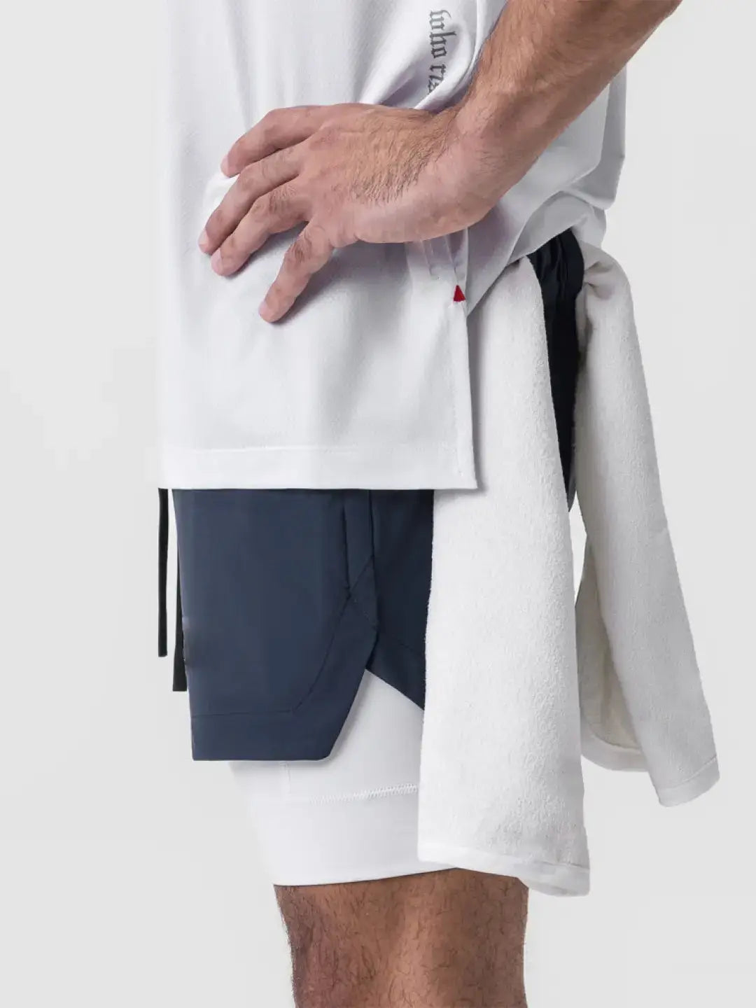 2-in-1 navy shorts with inner compression media pockets, outer front pockets, a back zip pocket and a utility loop for training essentials.