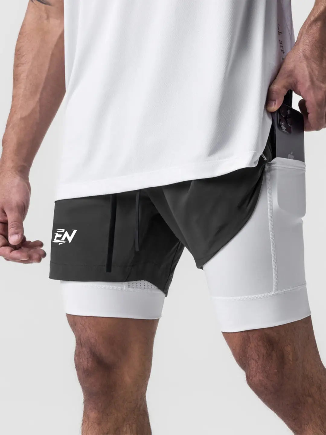 2-in-1 grey shorts with inner compression media pockets, outer front pockets, a back zip pocket and a utility loop for training essentials.
