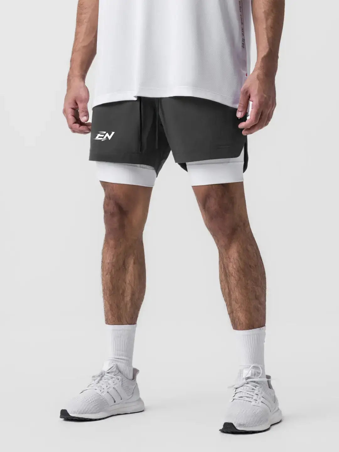 2-in-1 grey shorts with inner compression media pockets, outer front pockets, a back zip pocket and a utility loop for training essentials.