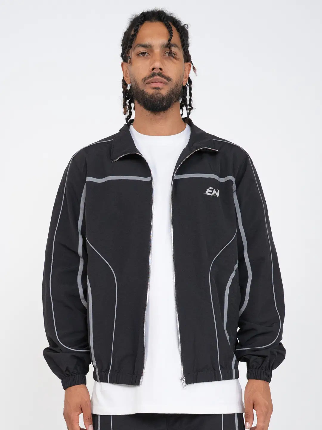 The Black jacket delivers a structured yet lightweight feel, while the relaxed-fit track pants ensure fluid movement and all-day comfort. 