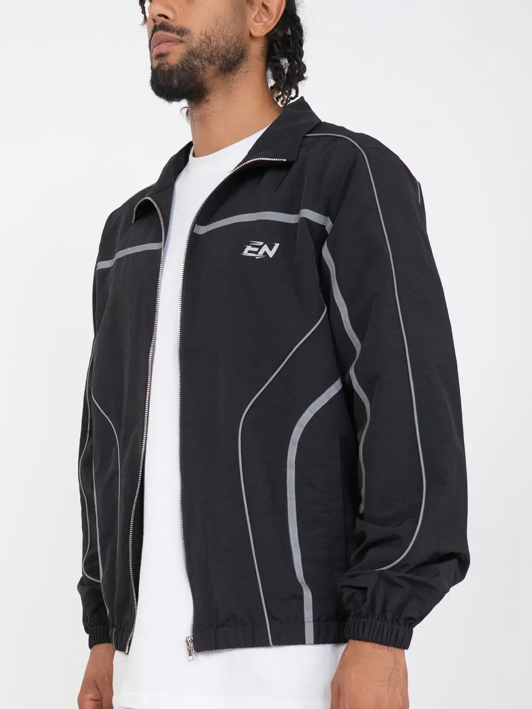 The Black jacket delivers a structured yet lightweight feel, while the relaxed-fit track pants ensure fluid movement and all-day comfort. 