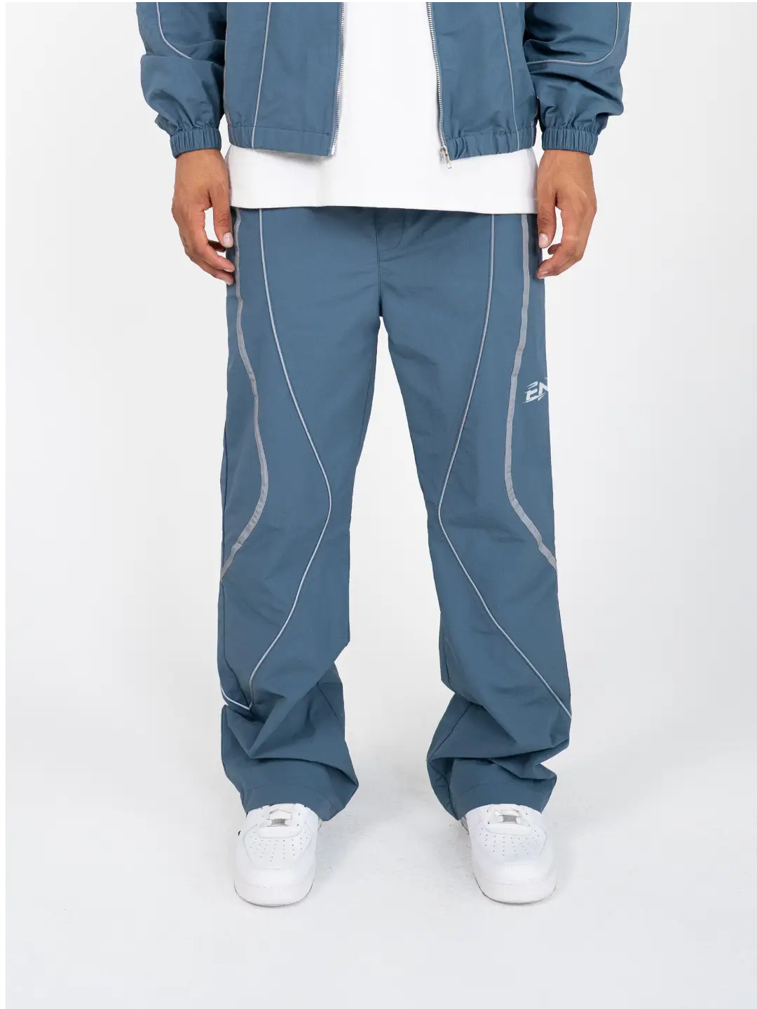 The Blue pant delivers a structured yet lightweight feel, while the relaxed-fit track pants ensure fluid movement and all-day comfort. 