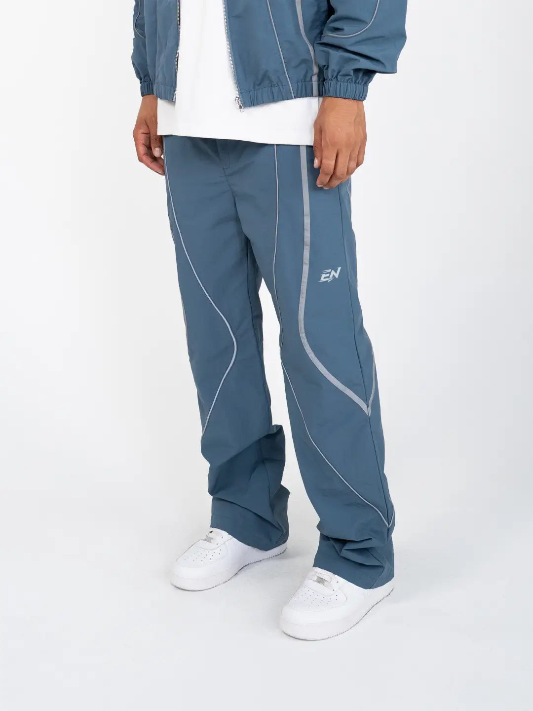 The Blue pant delivers a structured yet lightweight feel, while the relaxed-fit track pants ensure fluid movement and all-day comfort. 