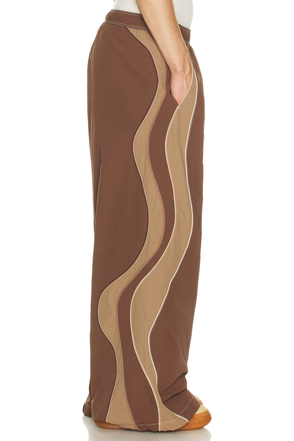 Brown and beige patterned pants on a white background